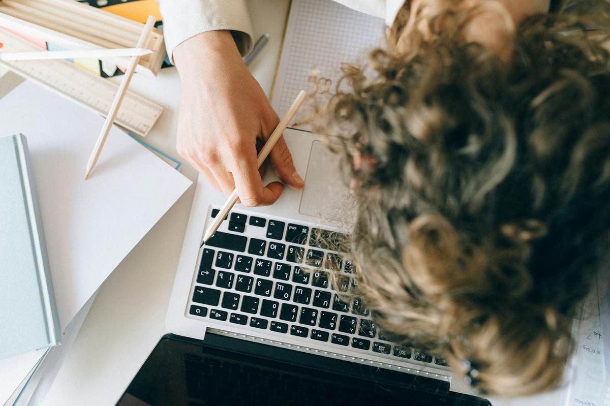 Exhausted content creator working late on laptop