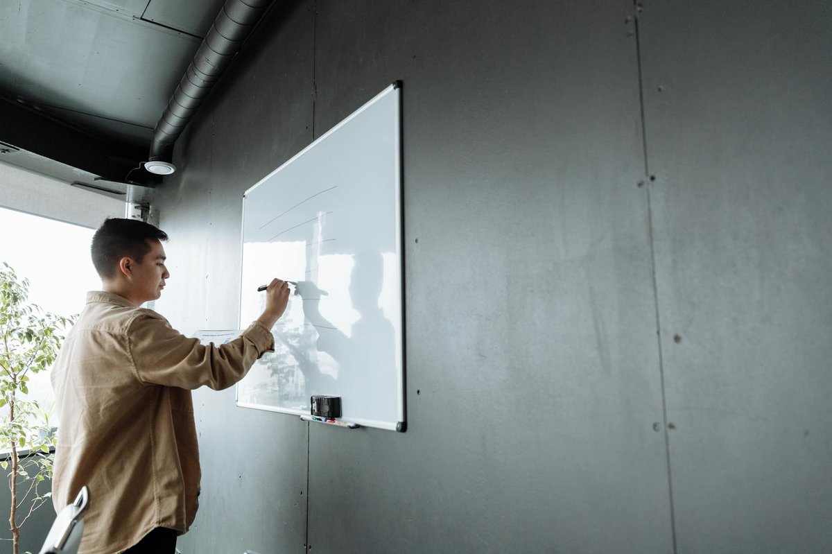 Creator brainstorming niche ideas for a paid community on whiteboard