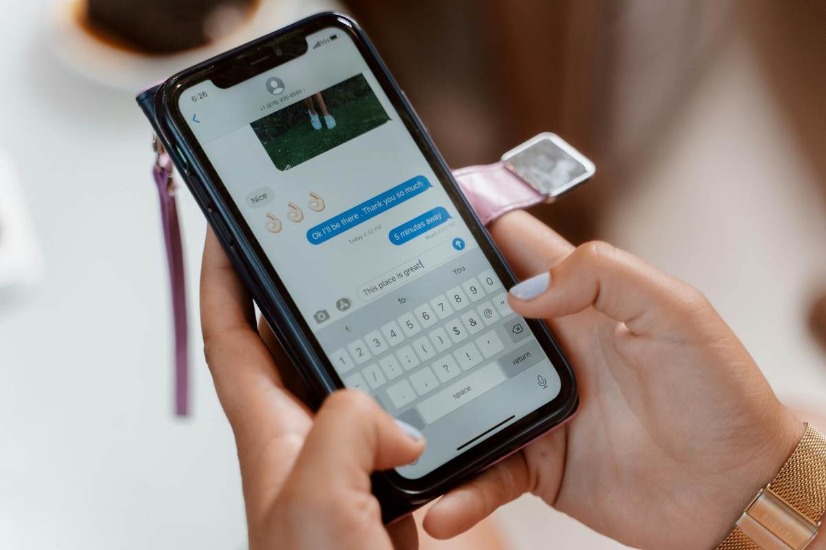 Person sending messages on smartphone for warm audience outreach to promote paid community