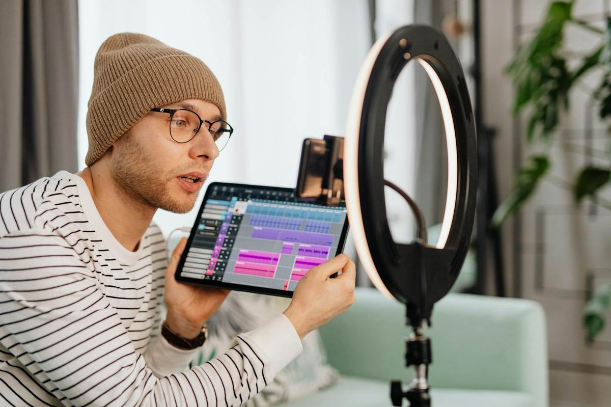 Creator recording content in a professional studio setup for exclusive paid audience