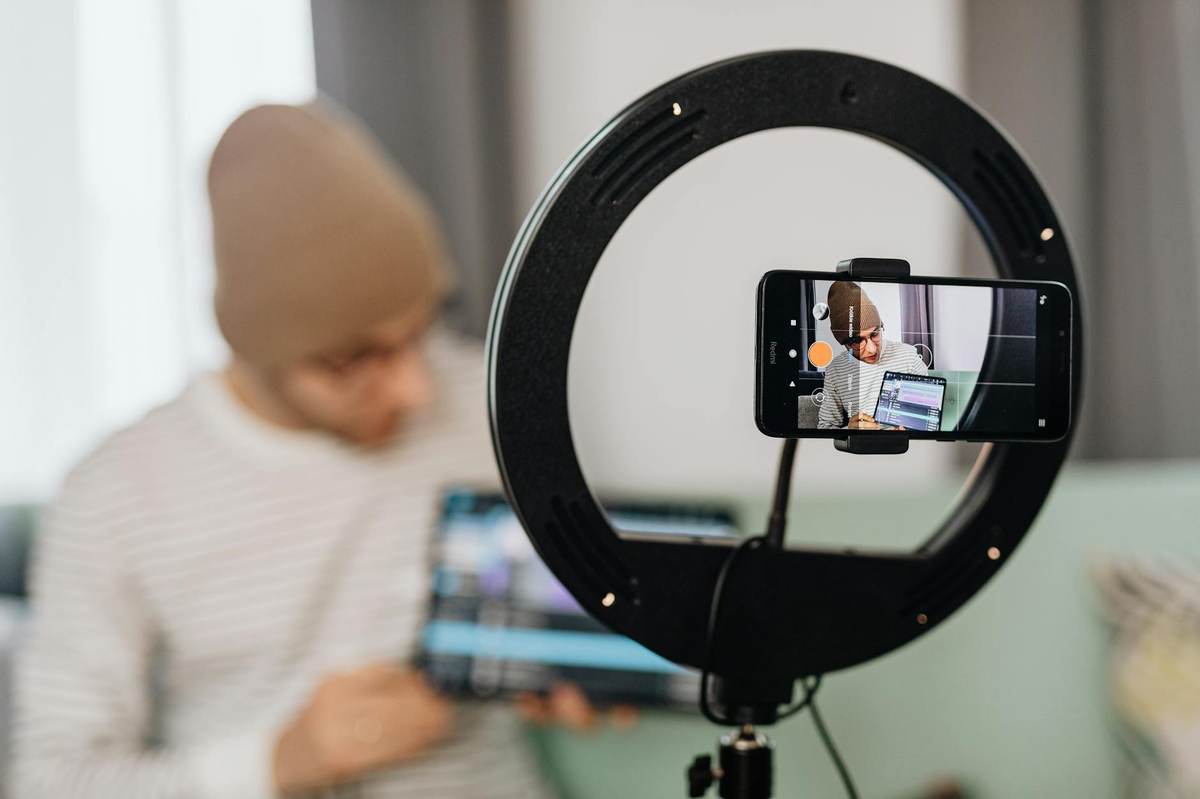 Creator recording video content on smartphone for social media monetization