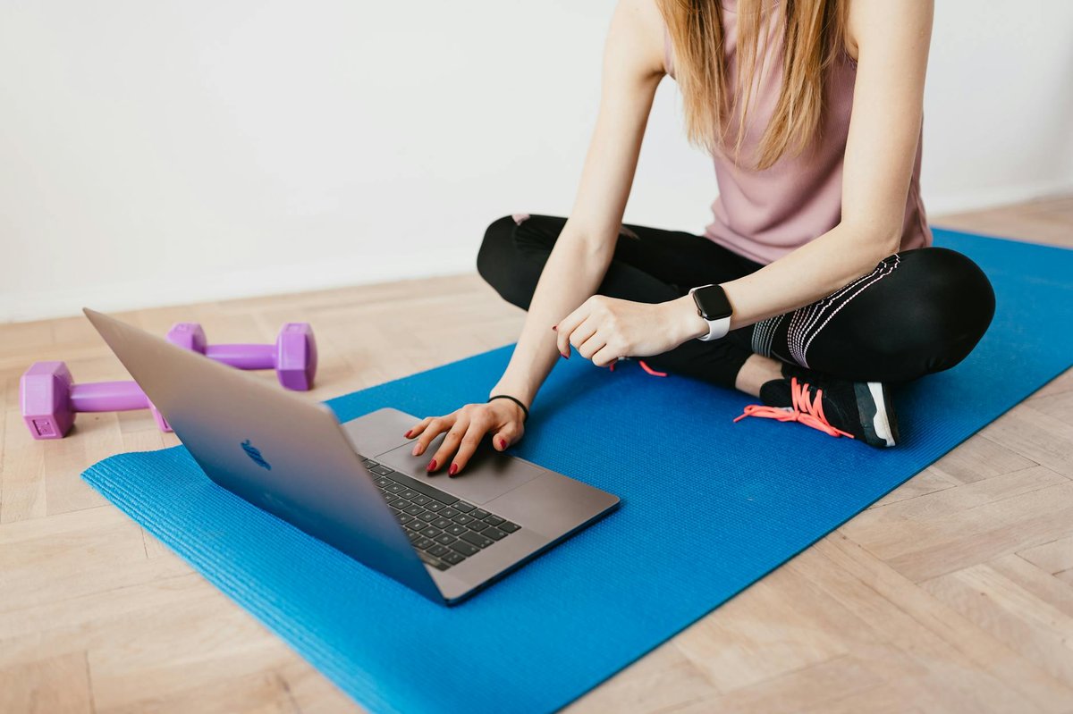 Fitness coach working on laptop building paid Telegram channel