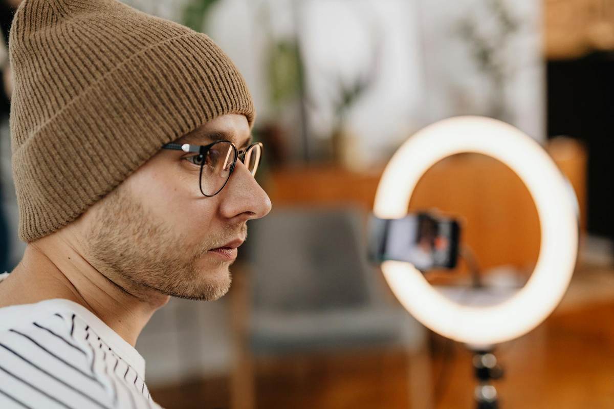 Content creator checking audience engagement analytics on smartphone