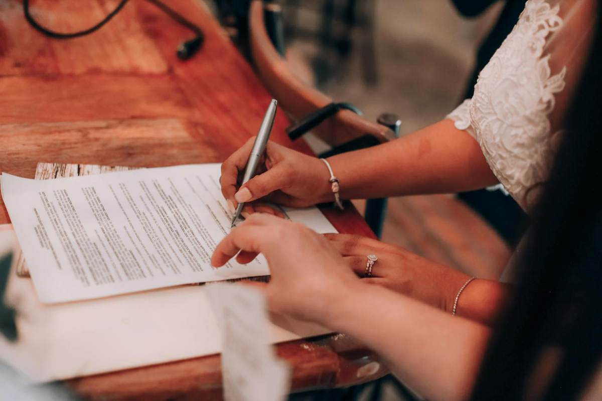 Person writing structured rules and guidelines for a paid Telegram community template